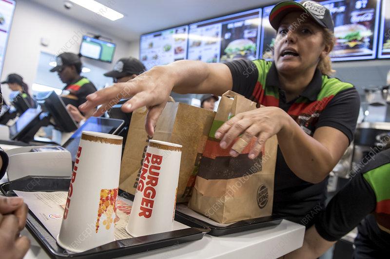 Editorial use only  
Fast food worker. Woman working in the first Burger King opened in Brussels, Belgium. Photographed in Auderghem, Brussels, Belgium.