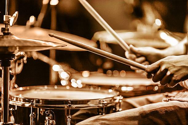view and shot from backstage: drummer playing hi hat and snare drum