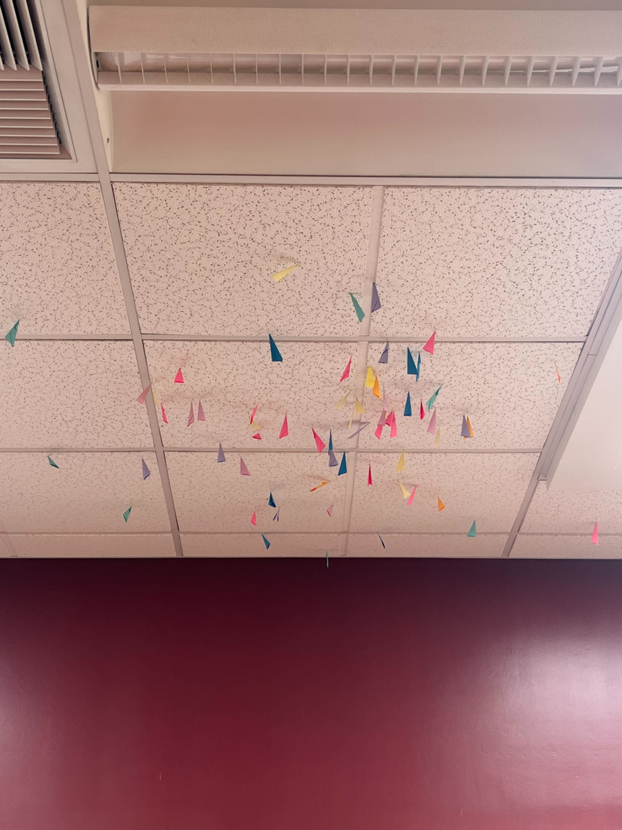 Paper darts stuck in the ceiling of the school library.