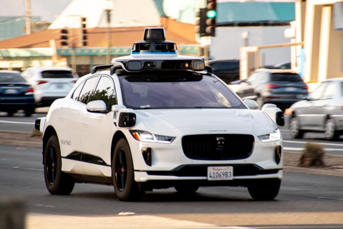 A Waymo vehicle drives down El Camino Real in Millbrae, CA.