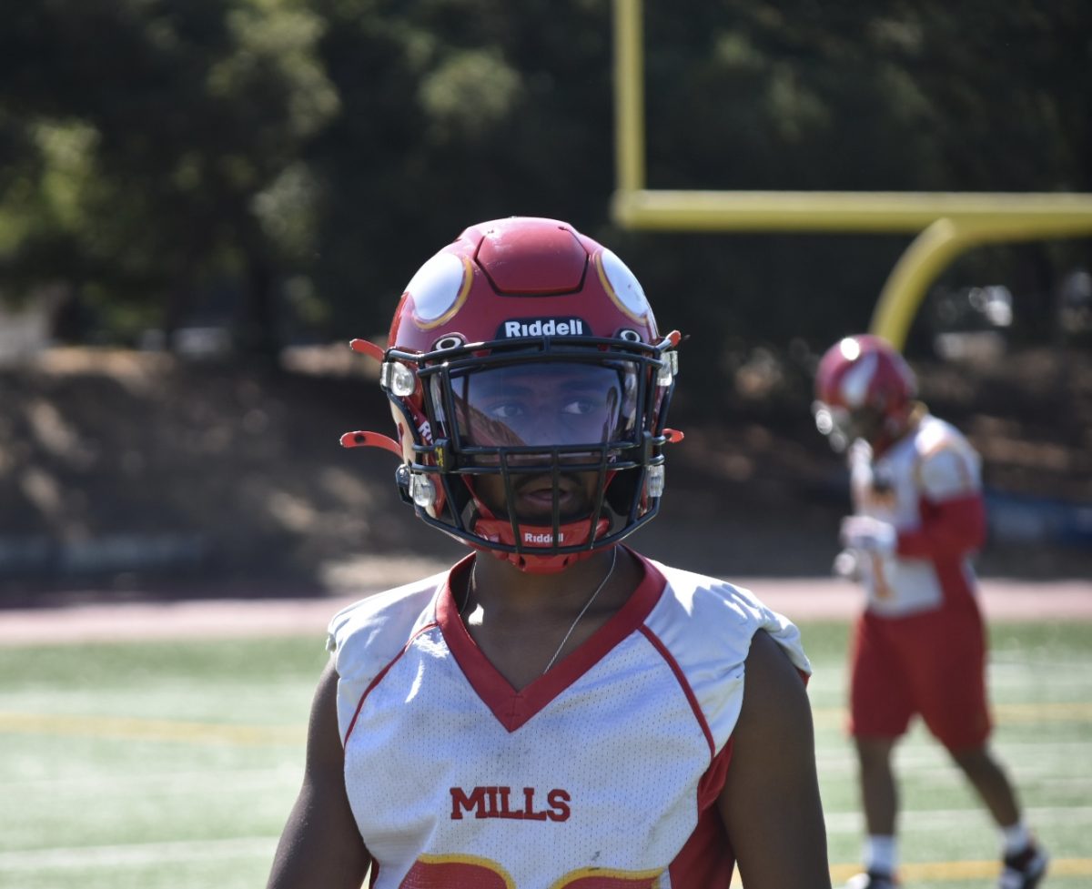 Student Athlete: Shamal Kumar (12) playing football on the field 