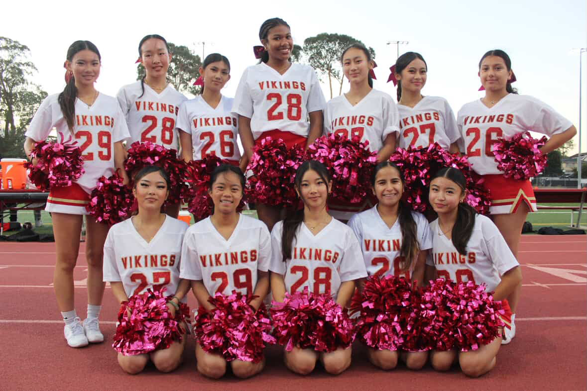 SQUAD PICTURE: The Mills cheerleading team poses for a group photo with their pompoms.