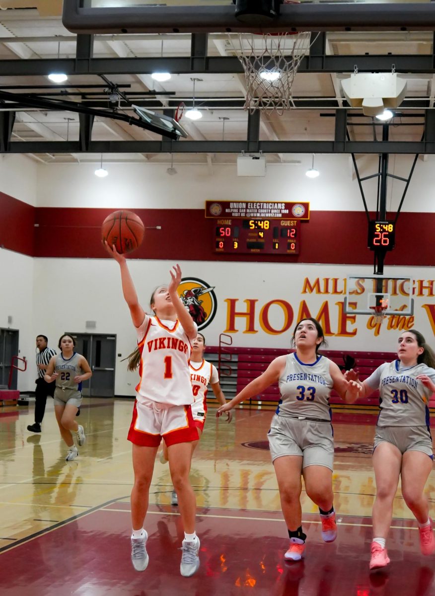 Freshman guard Makena Hoover (9) banks in the fast break layup 