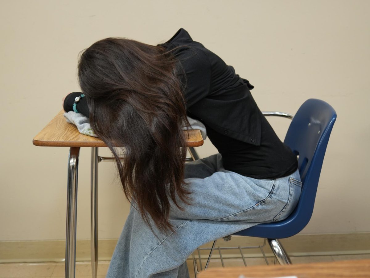 Mills High School student sleeping in class after staying up late doing homework.