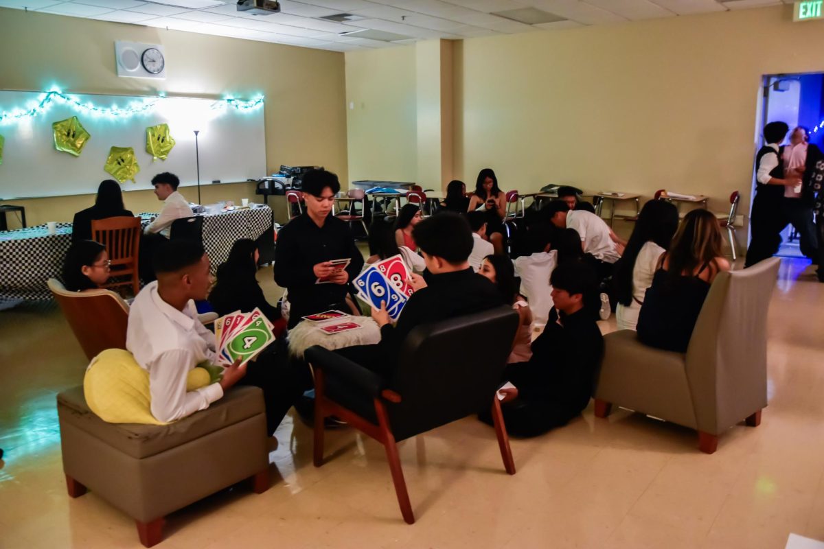 During Mills High School 2025 Homecoming, this picture shows how students seem to be un-intrigued during the dance and would rather play cards instead