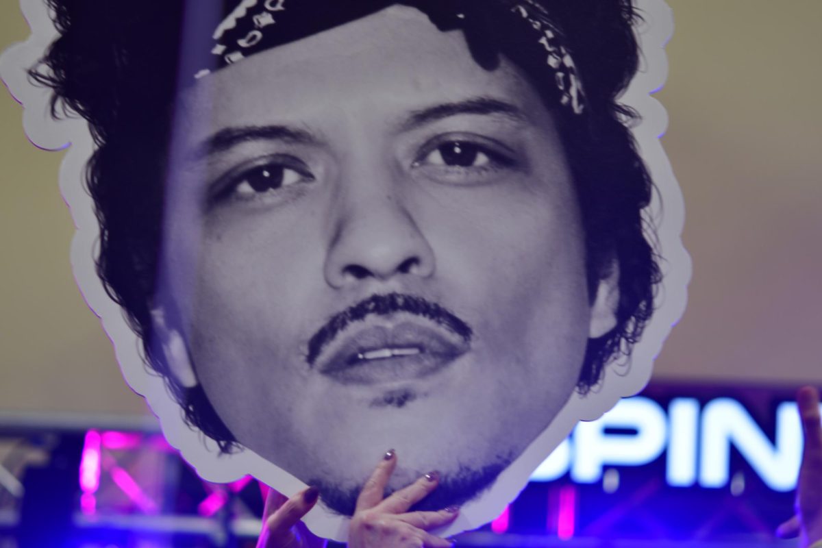 CUTOUT: Bruno Mars cardboard head cutout held up in the air in a crowd