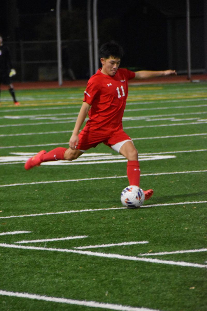 Boys varsity soccer Ethan Cabrera (12) getting ready to kick soccer ball 