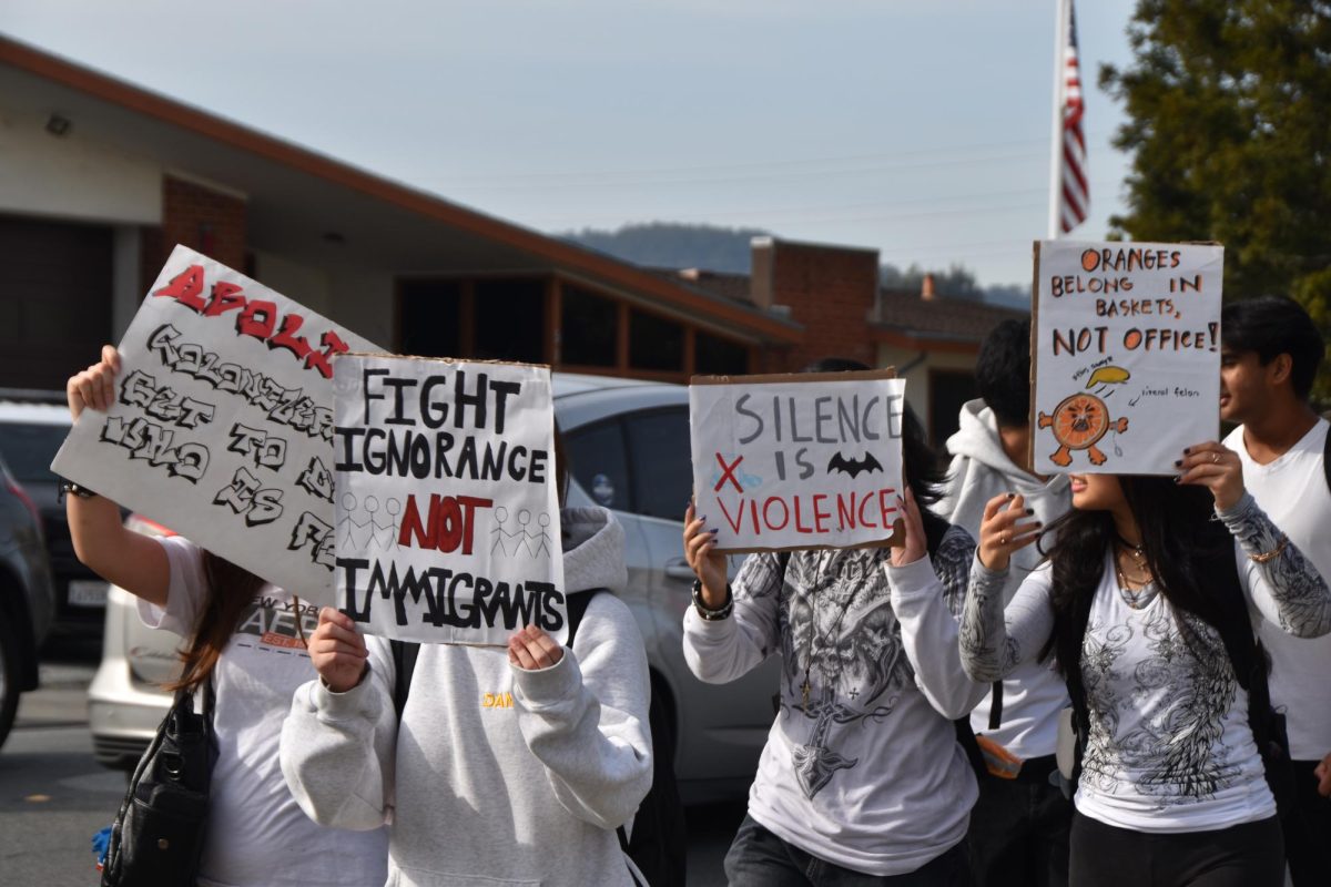 Mills students peacefully protesting  outside of Millbrae City Hall with signs