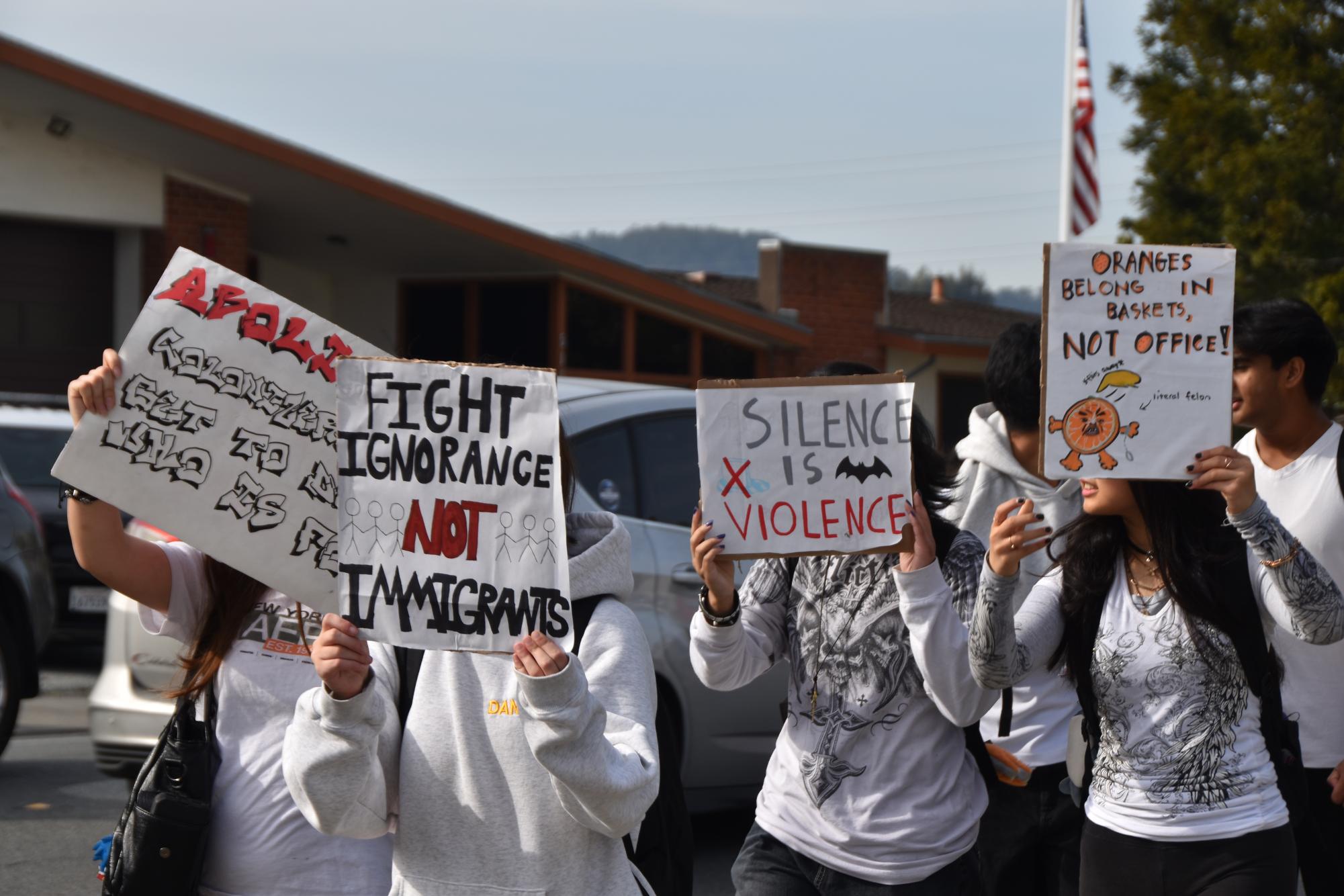 Mills students peacefully protesting  outside of Millbrae City Hall with signs