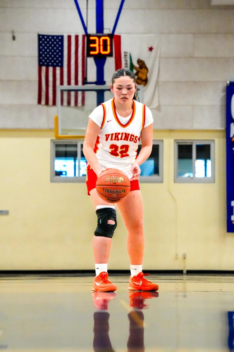 Senior Layla Wong (12) at the free throw line calmly ready to shoot 