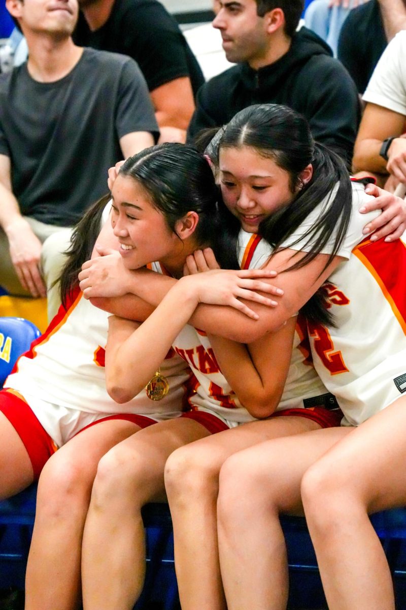Kaylee Huynh hugged by her teammates Kelly Ho and Layla Wong after win 
