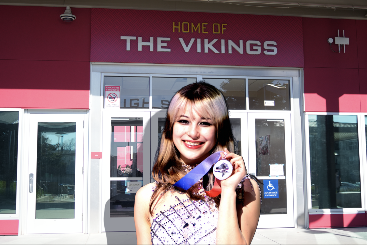 Olympic gold medal winner Alysa Liu shows off her medal to the camera